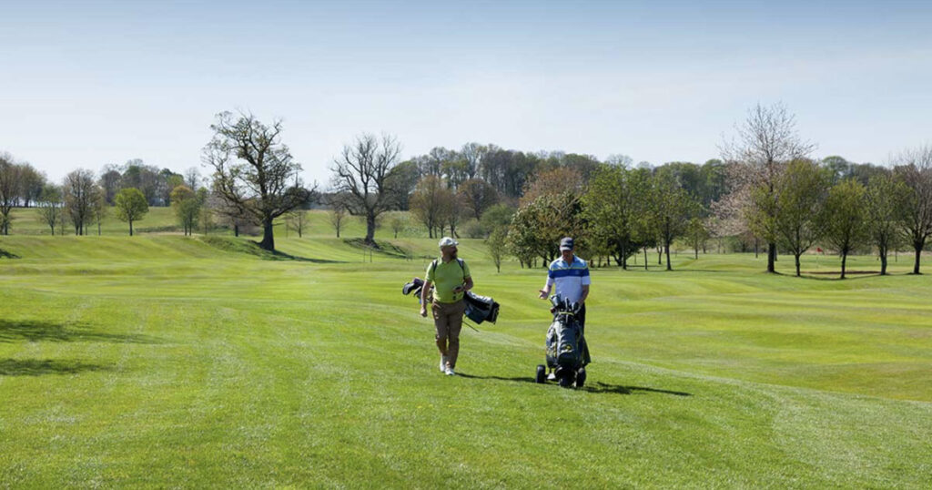 Golfers walking along the golf course for the Rotary Golf Day at Kirkby Lonsdale Golf Club