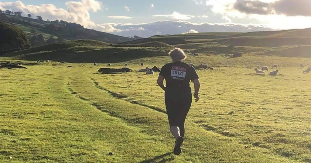 Gina Pennington running through fields in preparation for Running Manchester Marathon